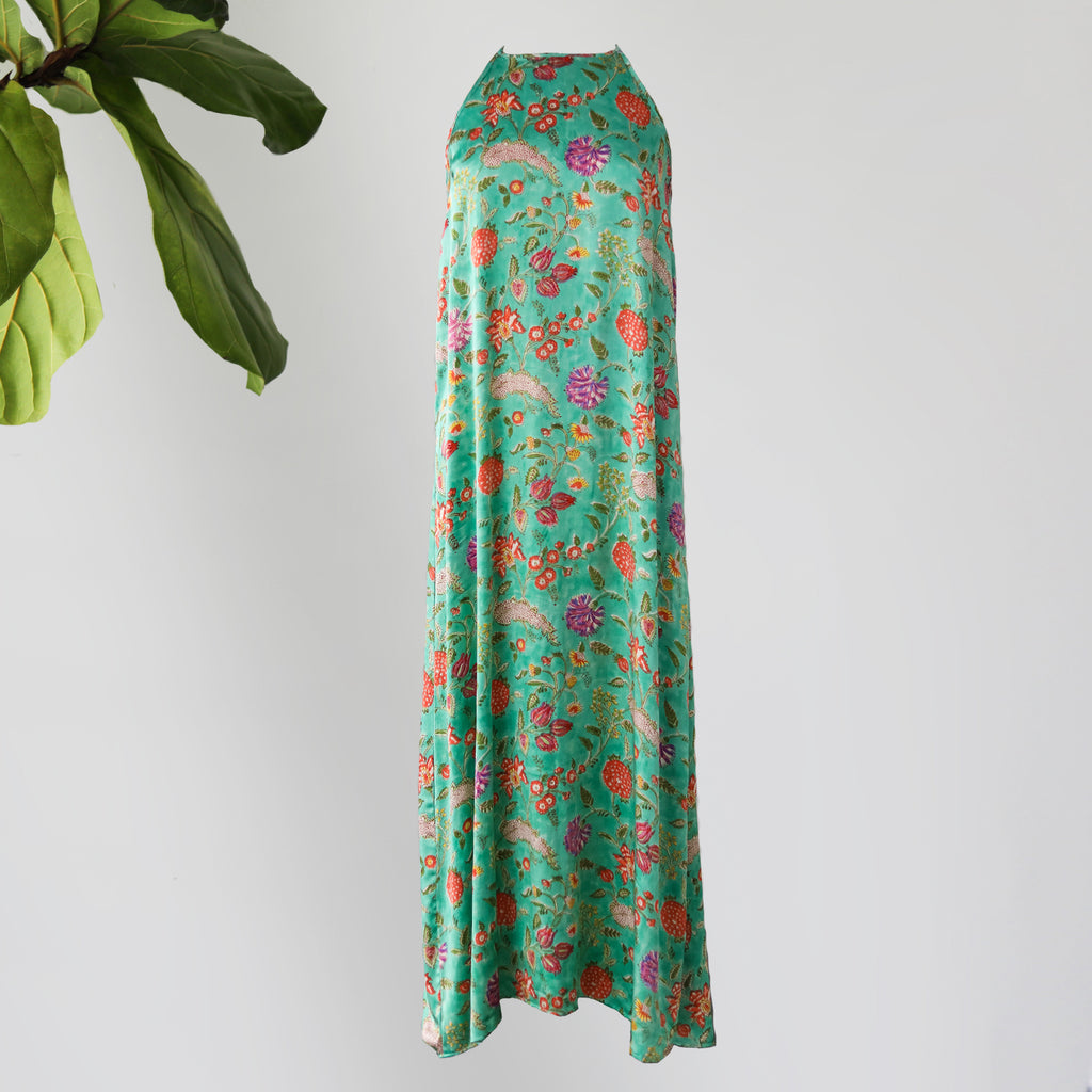 Silk green column dress with botanical print.